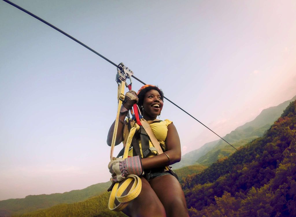 Woman zip lining at NOC in Smoky Mountains