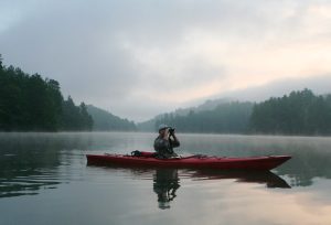 a person boating on lake santeetlah in the nc smoky mountains