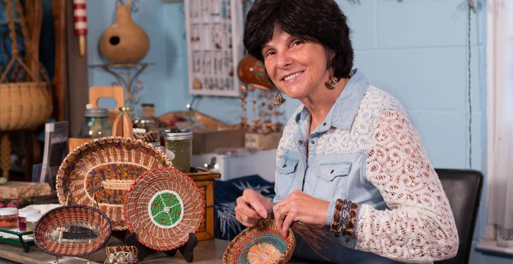 An artist showcasing handmade crafts along the Blue Ridge Craft Trails.